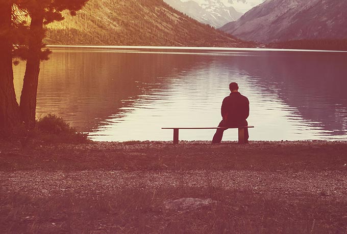Young man sitting alone bereaved by suicide