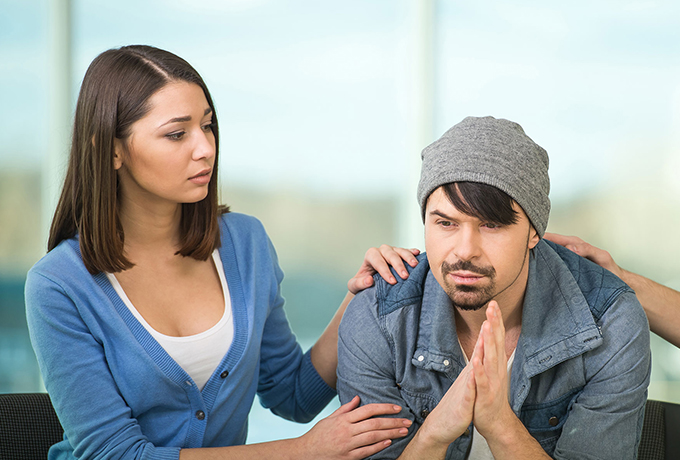 Women comforting man thinking about suicide