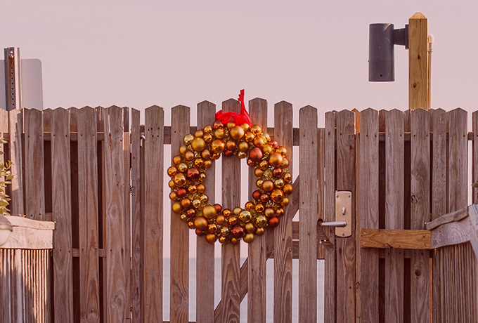 Entertaining guests with a Christmas wreath hanging on a gate