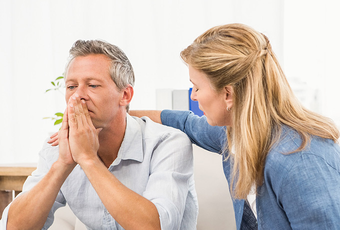 Women comforting a man after a suicide attempt