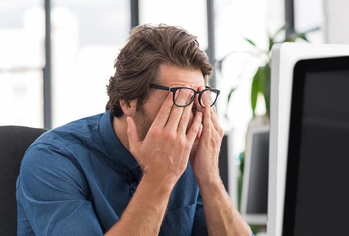 Man struggling to cope at work - take a mental health day