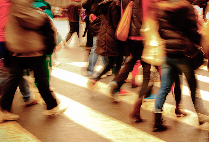 People walking along a busy street