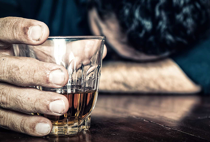 Depressed man drinking alcohol
