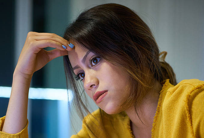 Feel anxious - Women sat looking concerned, worried about anxiety