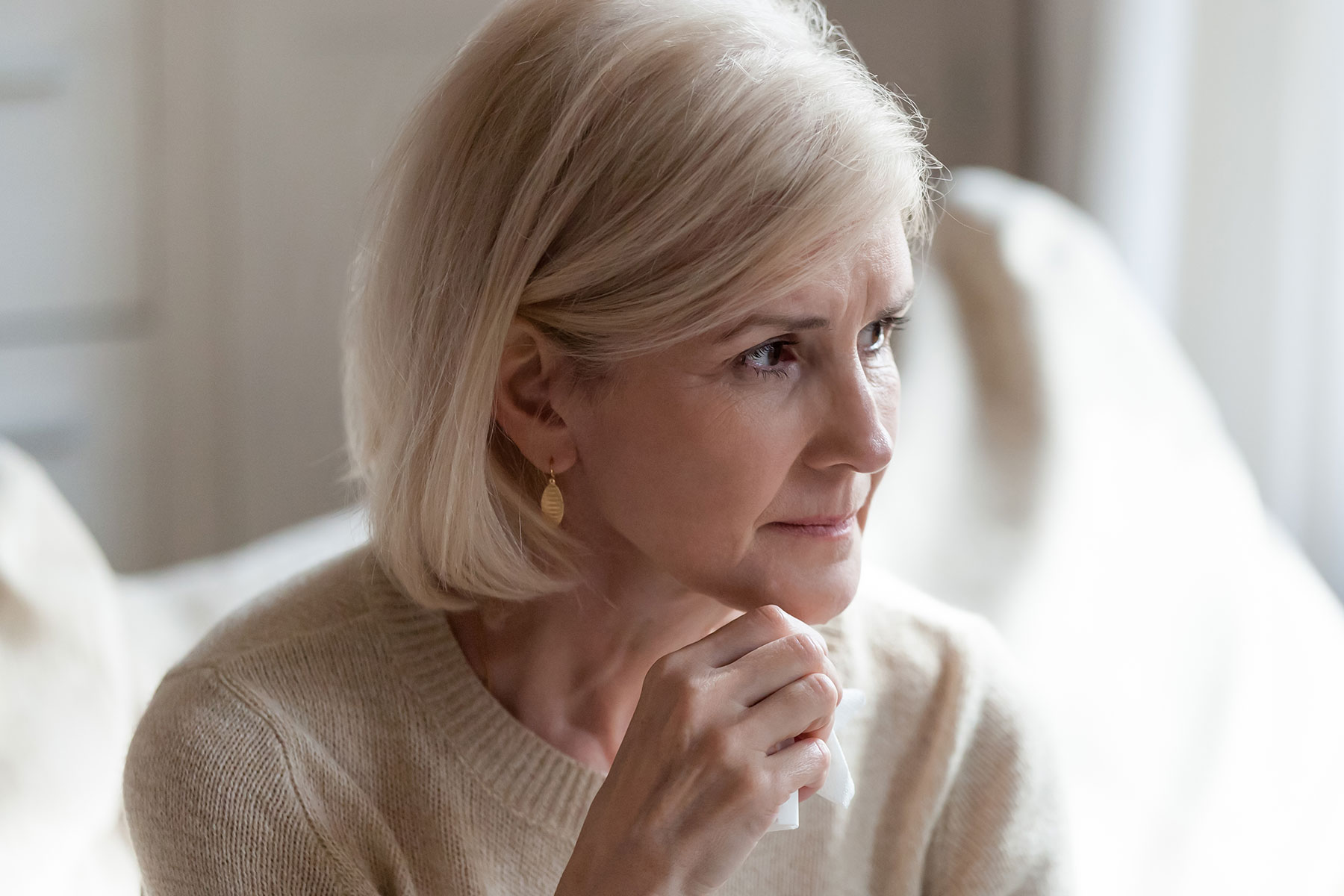 Women sat on a couch looking concerned