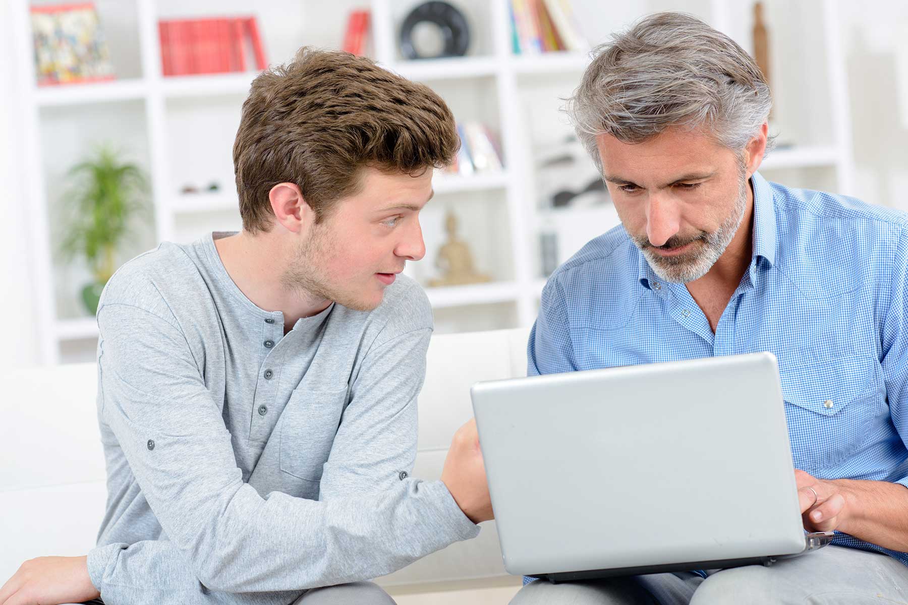 Father and son looking at a laptop
