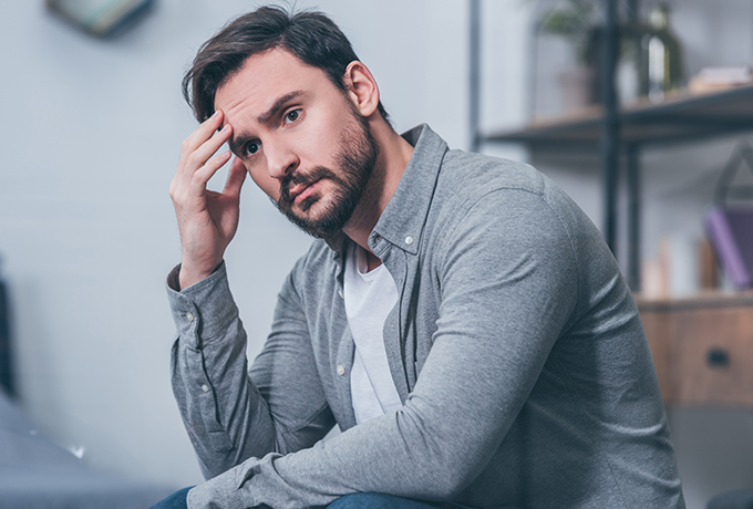depressed man sat contemplating